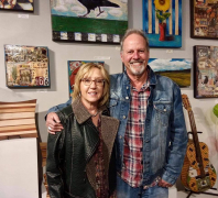 <p>We always enjoy seeing Dave and Donna Newman shown here standing in front of his awesome art work.</p>