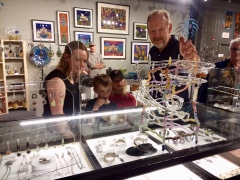 <h5>Bandhu Scott Dunham showing little ones how his new hand blown glass marble sculpture is played</h5>