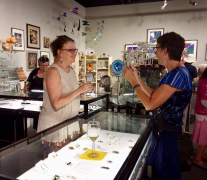 <p>Our jeweler extraordinaire, Lesley McKeown, showing her jewelry to an admiring customer.</p>