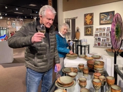 <p>Admiring all the great pottery we offer.</p>