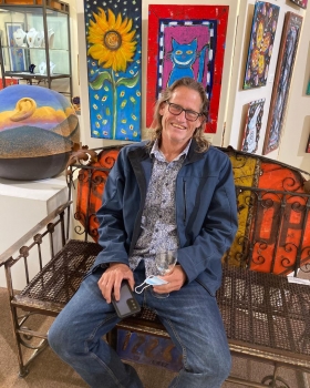 <p>Local artist, John Hoyt enjoying some relaxing time while listening to Kenny James.</p>