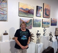 <p>Artist, Sandy Applegate, next to her amazing watercolor and ink paintings.</p>